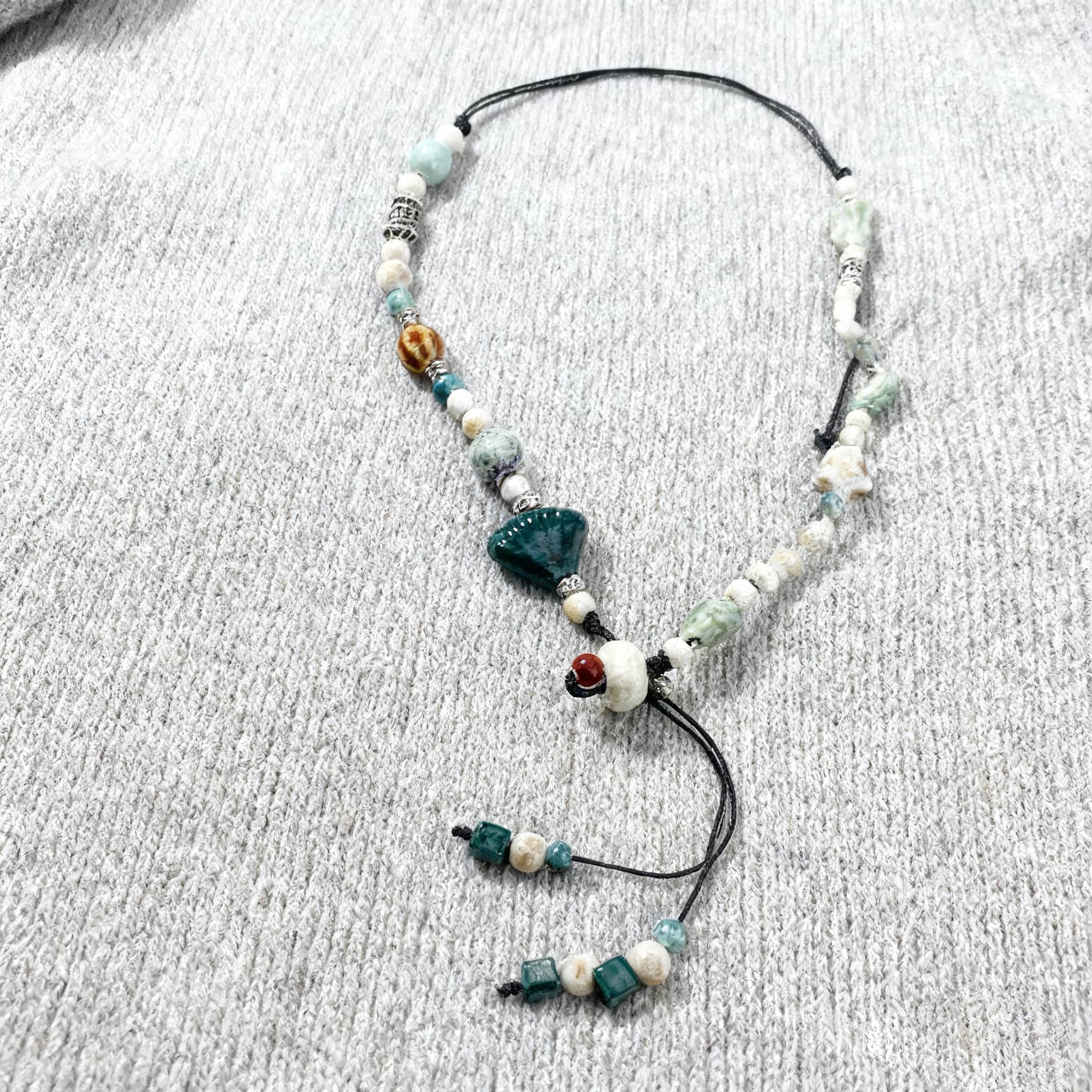 Unique ceramic scallop necklace with assorted beads and adjustable design for a stylish look