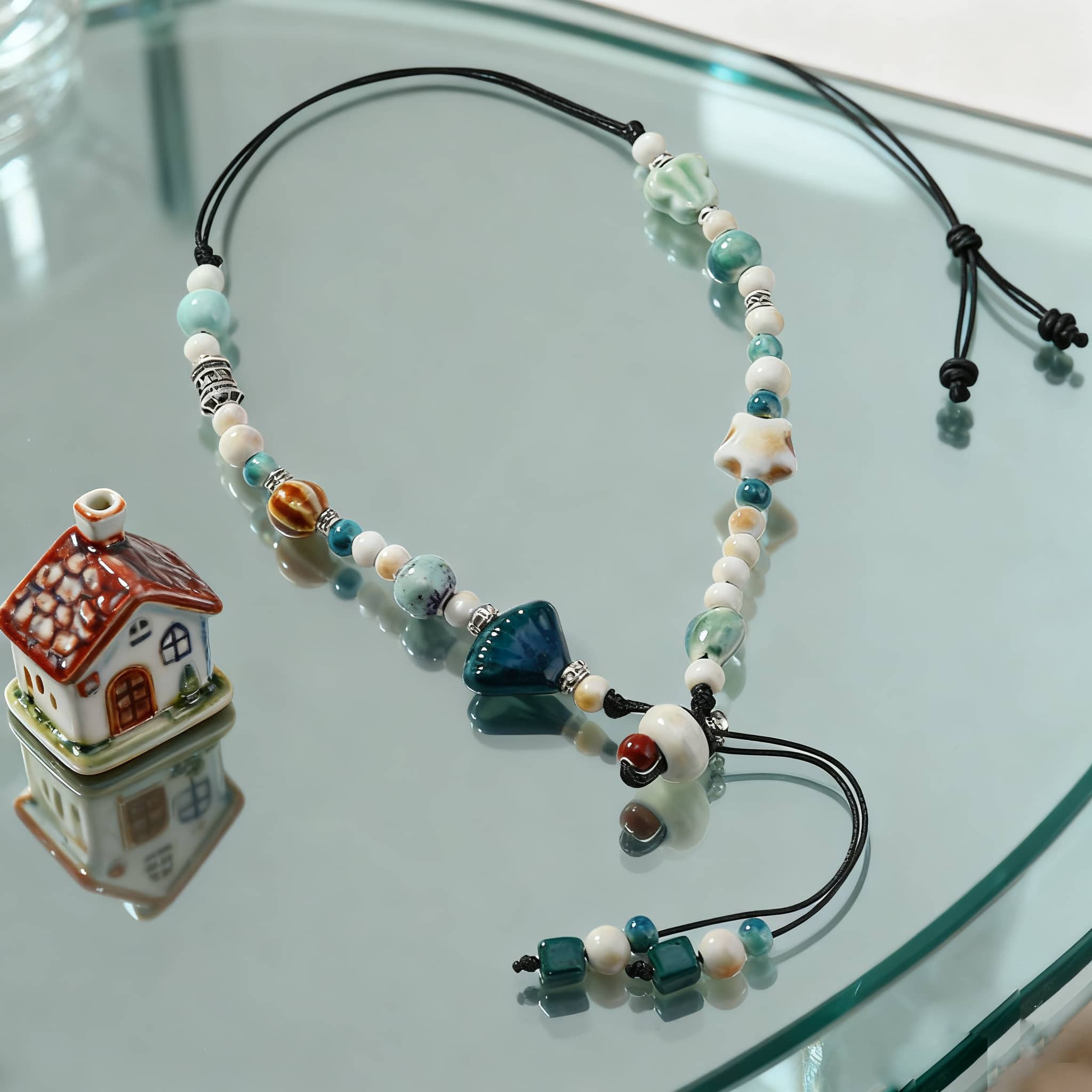 Ceramic scallop necklace featuring blue and white beads with adjustable length for a unique beach-inspired look