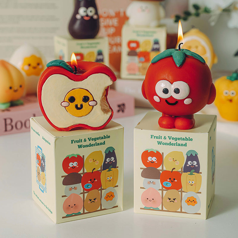 Hyper realistic food candle set featuring a cute tomato and bitten apple on Fruit and Vegetable Wonderland boxes