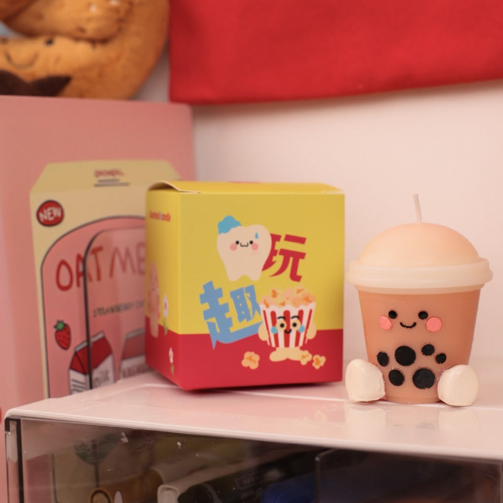 Hyper realistic food candle shaped like a cute bubble tea drink with smiley face and tapioca pearls