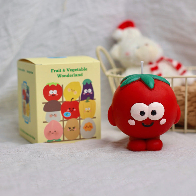 Cute red hyper realistic food candle shaped like a smiling tomato with green leaves on top