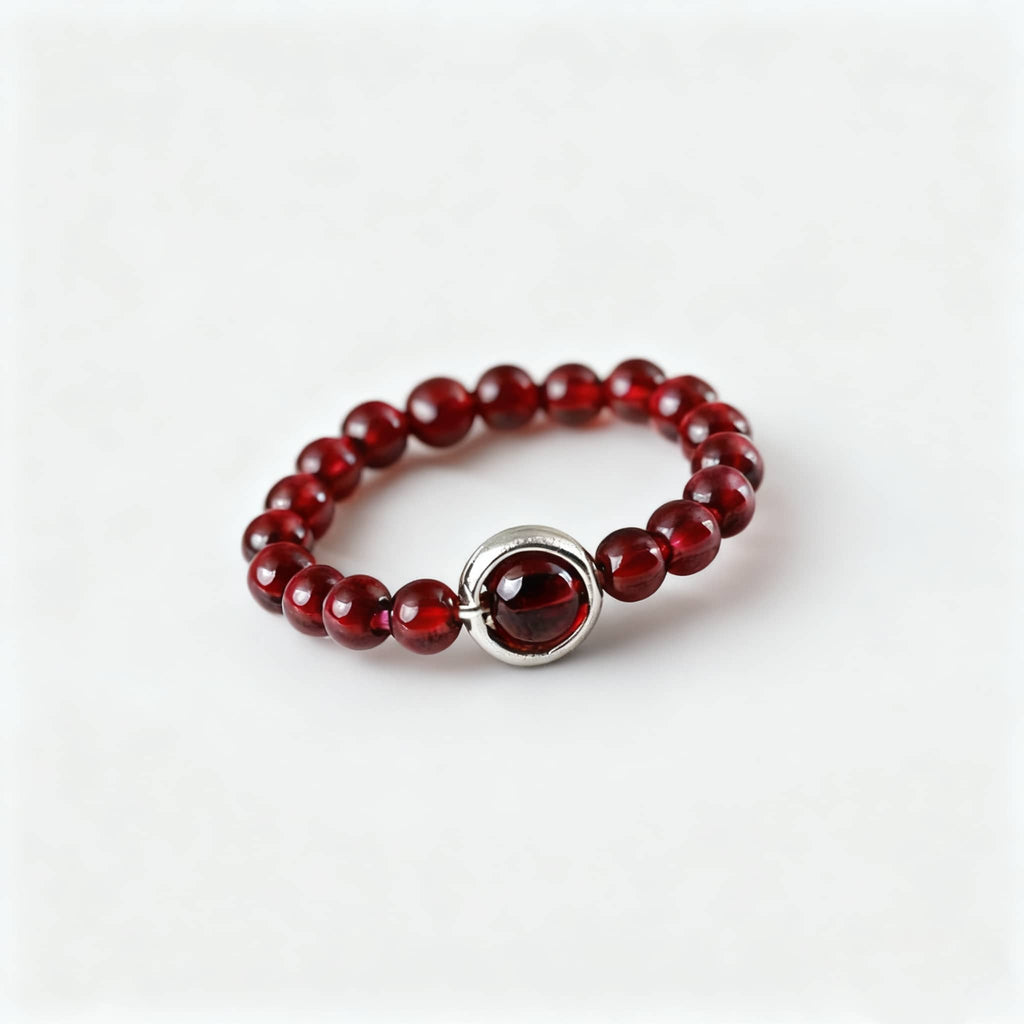 Garnet anxiety ring by 5 Senses featuring red beads and a silver accent for calming energy