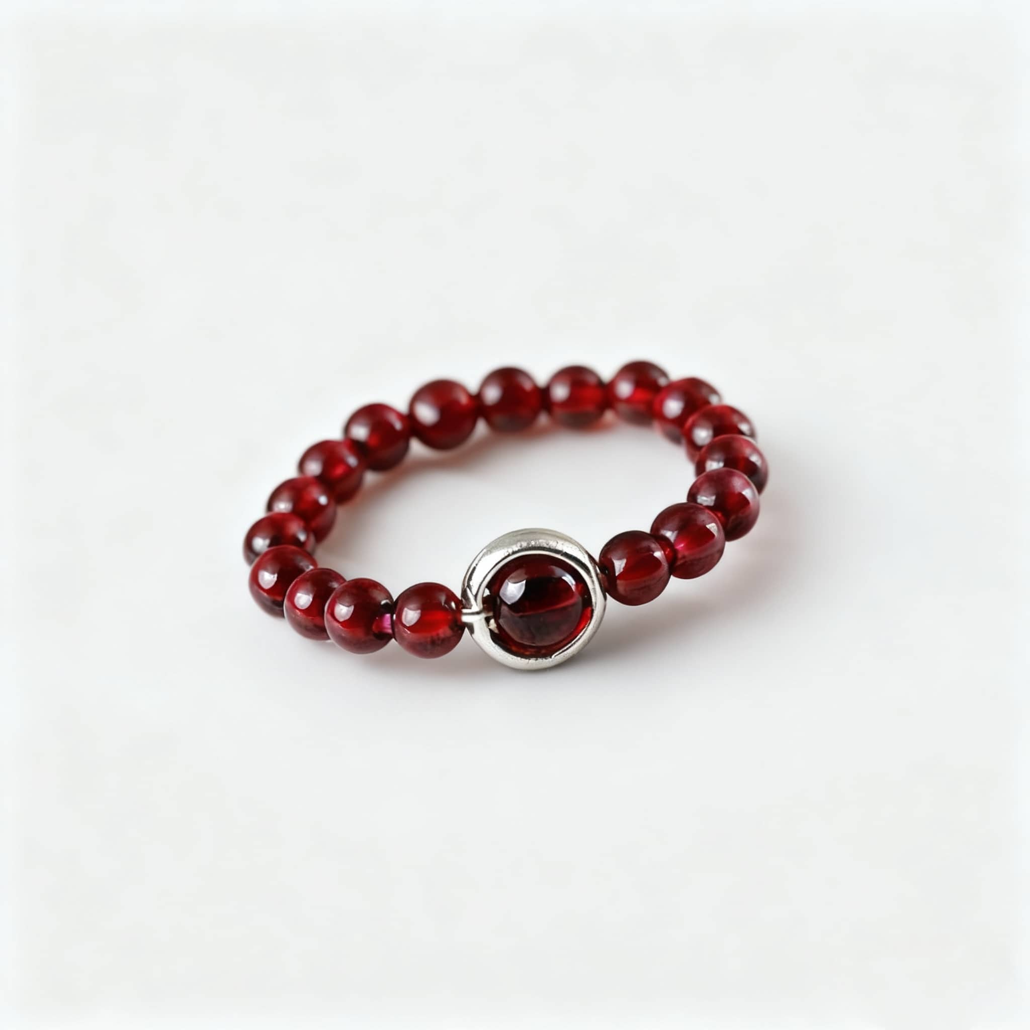 Garnet anxiety ring by 5 Senses featuring red beads and a silver accent for calming energy