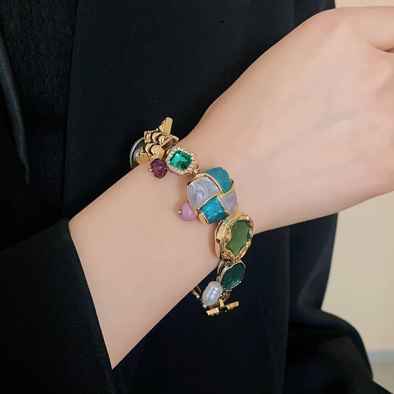 Stylish geometric color-block bracelet featuring colorful gemstones and gold accents for a trendy look