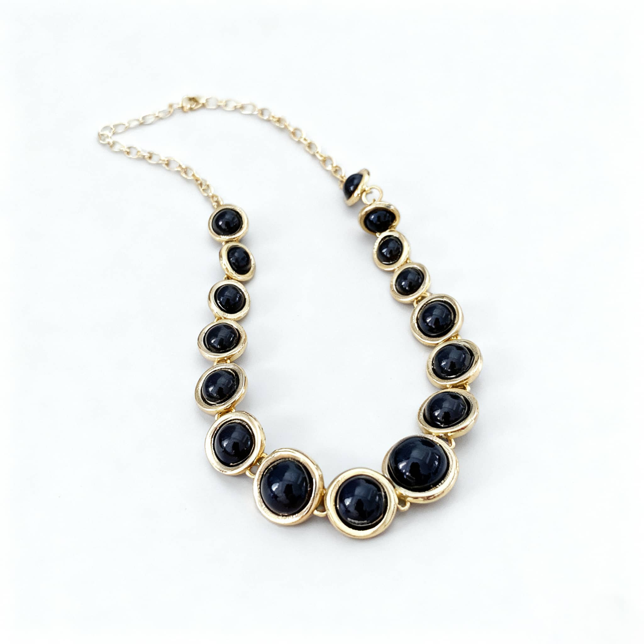 Elegant geometric resin pendant necklace with multiple black circular pendants and gold accents