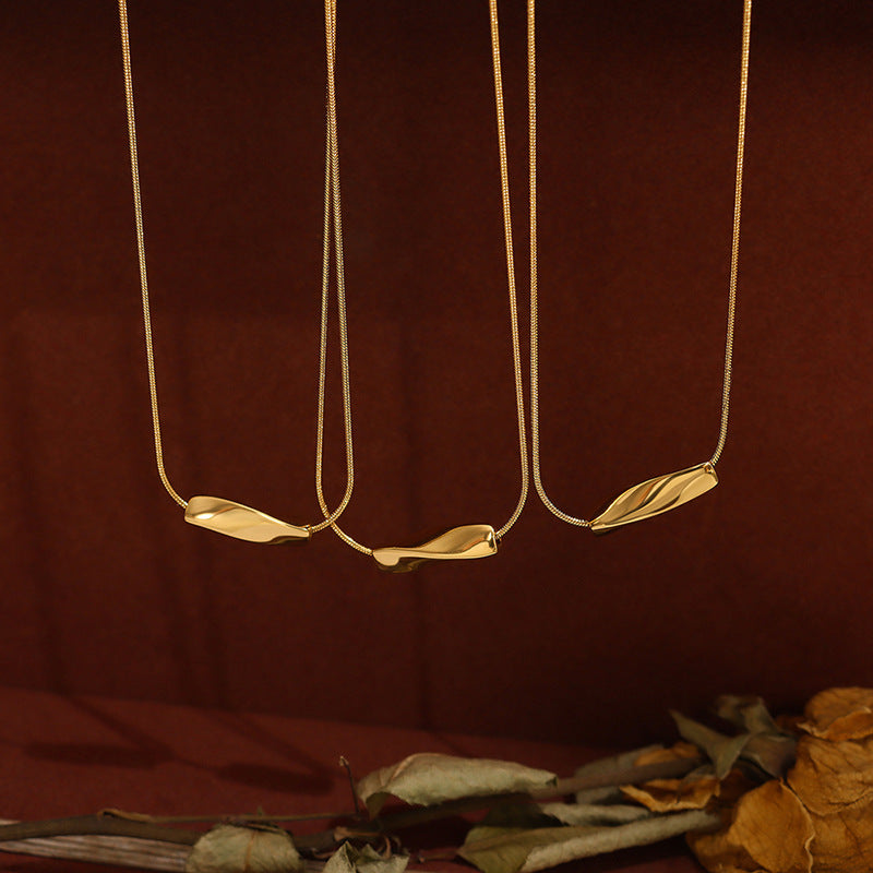 Three elegant angry necklaces in 18K gold steel necklace style with unique pendant designs on thin chains