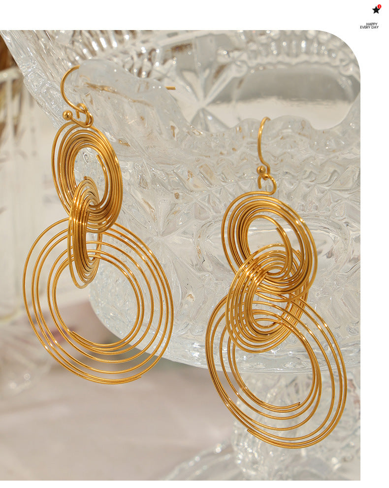 Gold hoop Anxious earrings designed as anxiety calming jewelry with concentric circular loops