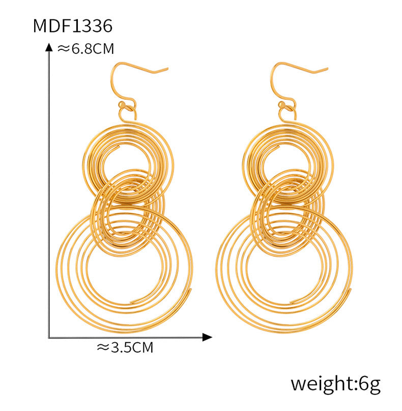 Gold tone anxiety calming jewelry earrings with concentric circular design measuring 6.8 cm in length