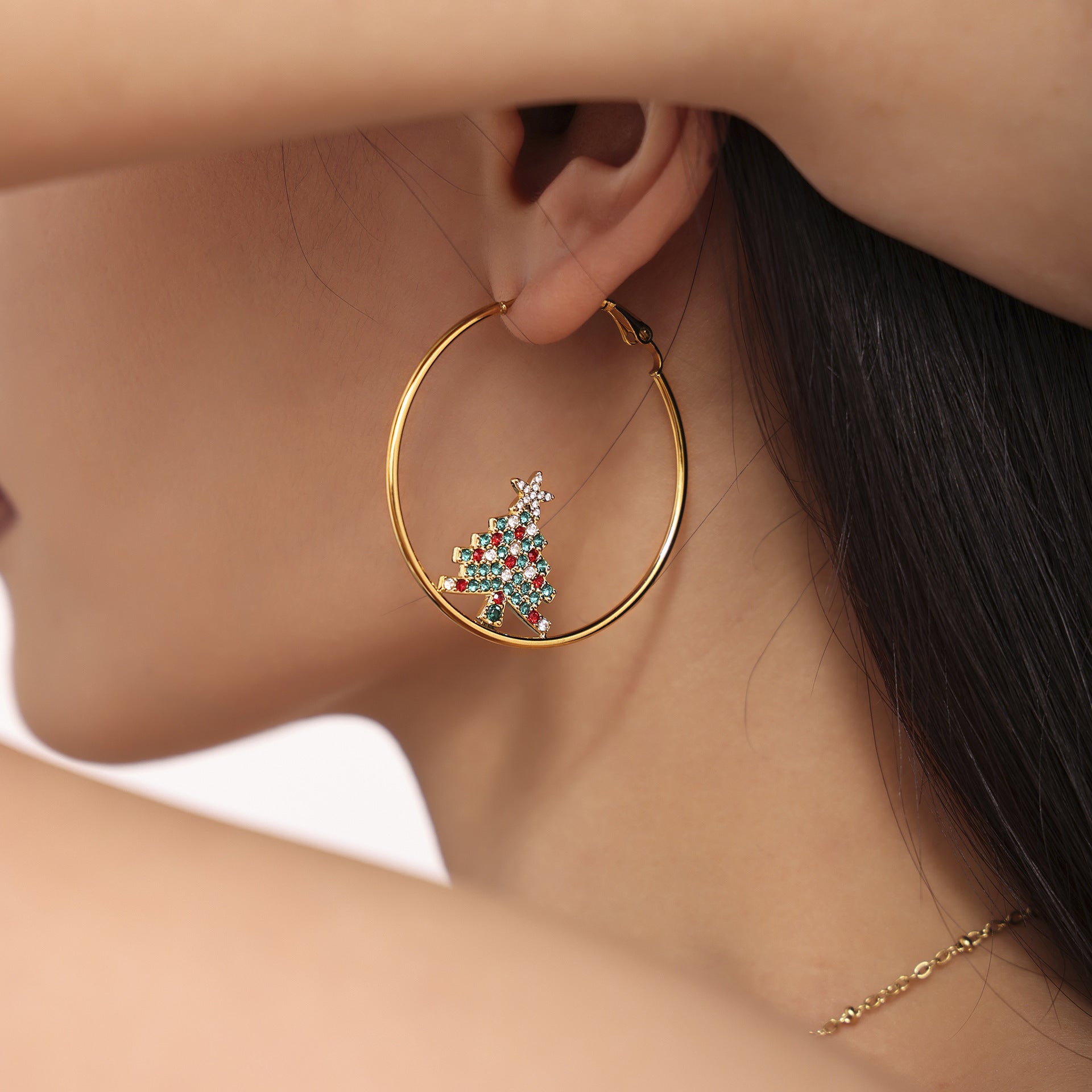 Gold hoop holiday charm earrings for women featuring a colorful Christmas tree charm