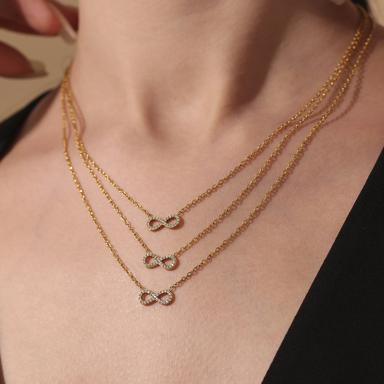 Layered gold infinity zircon necklace set worn on neck with delicate chain design
