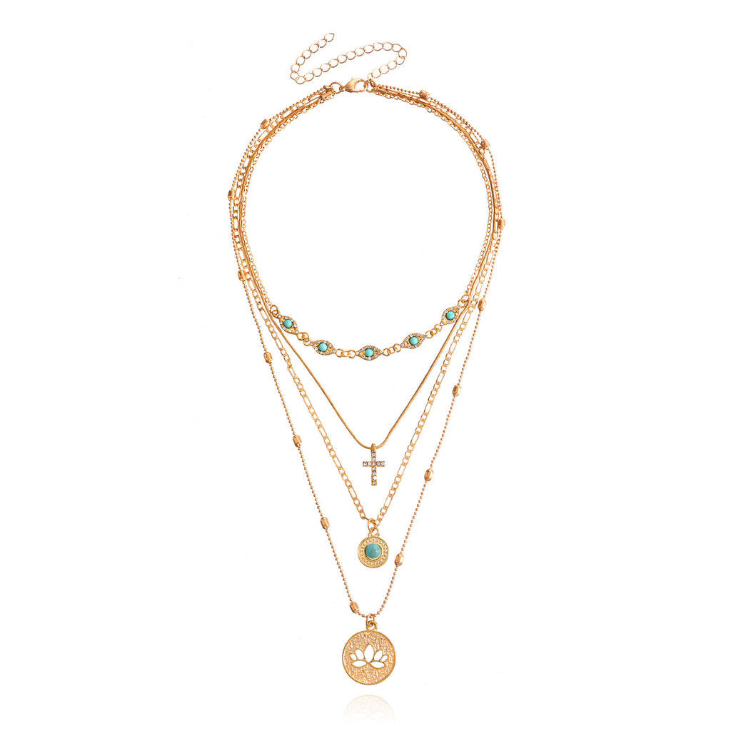 Gold multi-layered spiritual necklace with turquoise beads, cross, and lotus pendant