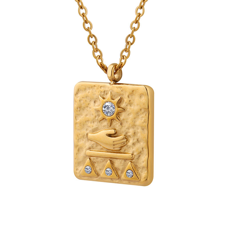 Gold textured solar guardian pendant necklace with sun, hand, and triangle design featuring small crystals