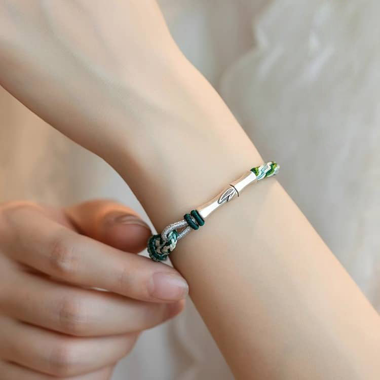 5 Senses green cord mindfulness bracelet with silver accents worn on a wrist