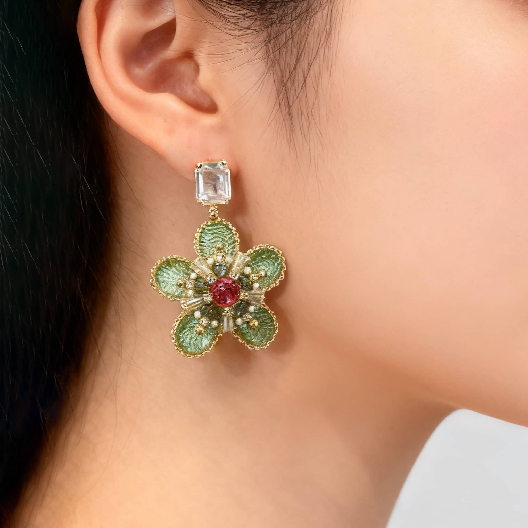 Elegant green crystal flower stud earrings featuring intricate floral design and vibrant accents