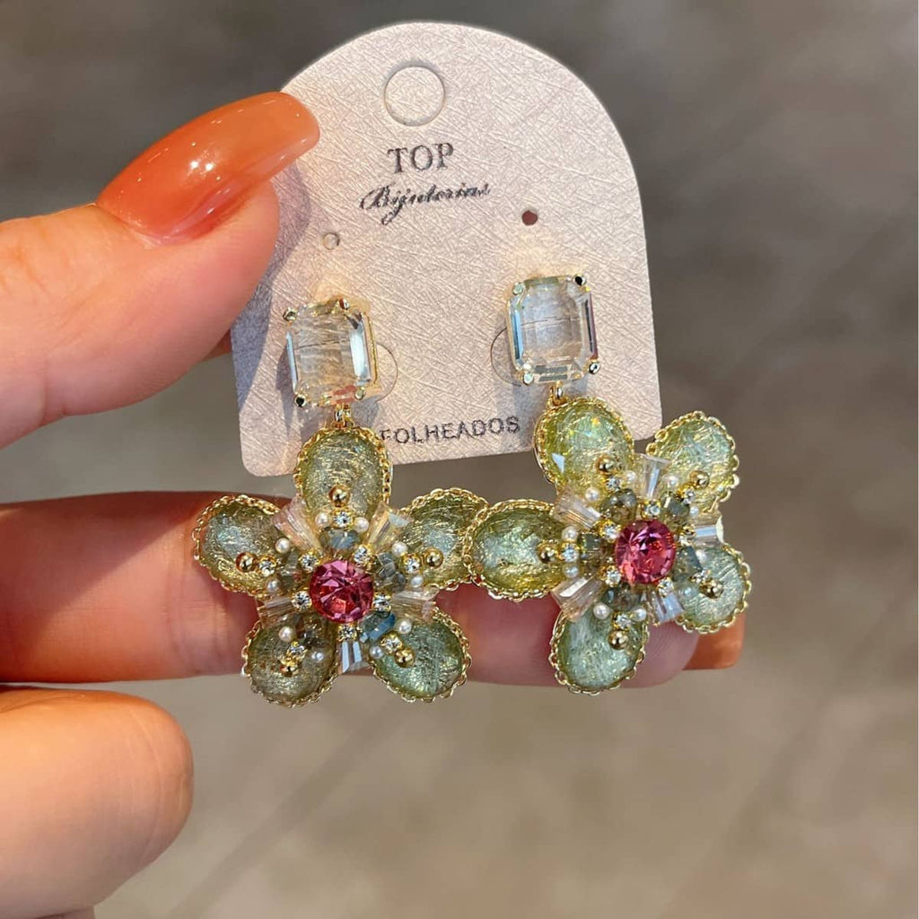 Green crystal flower stud earrings featuring intricate design and sparkling details