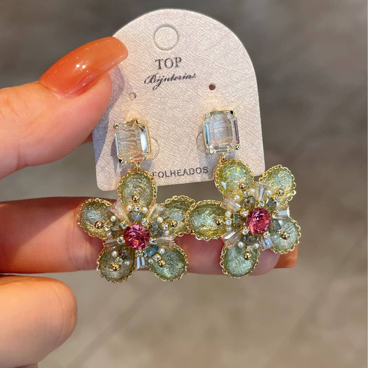 Green crystal flower stud earrings featuring intricate design and sparkling details