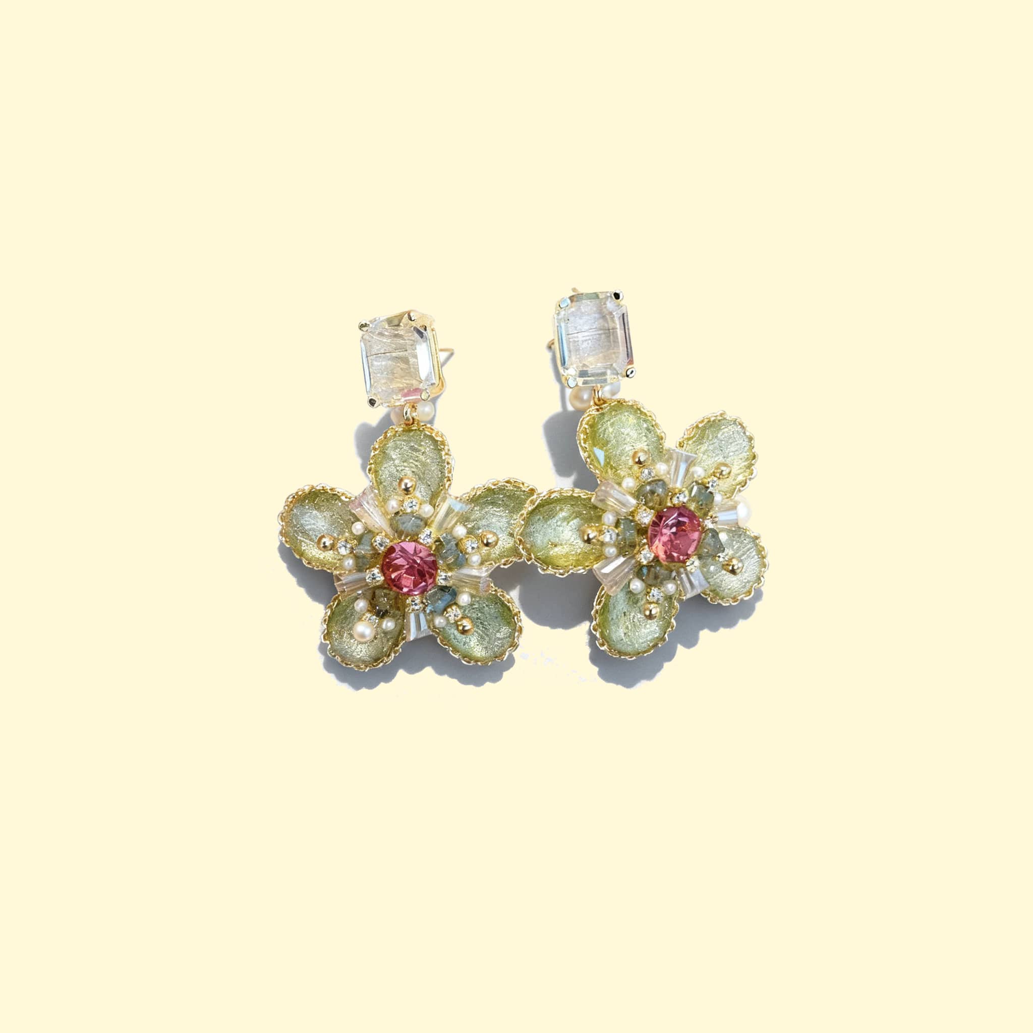 Green crystal flower stud earrings designed by 5 Senses with intricate floral detailing and colorful accents