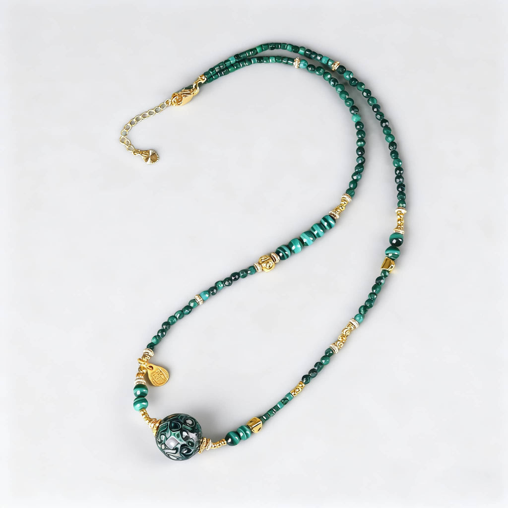 Green urushi mindfulness necklace featuring beads and a decorative pendant for calming energy