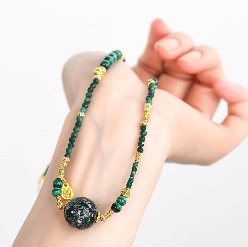 Green urushi mindfulness necklace featuring delicate gold accents and intricate beadwork