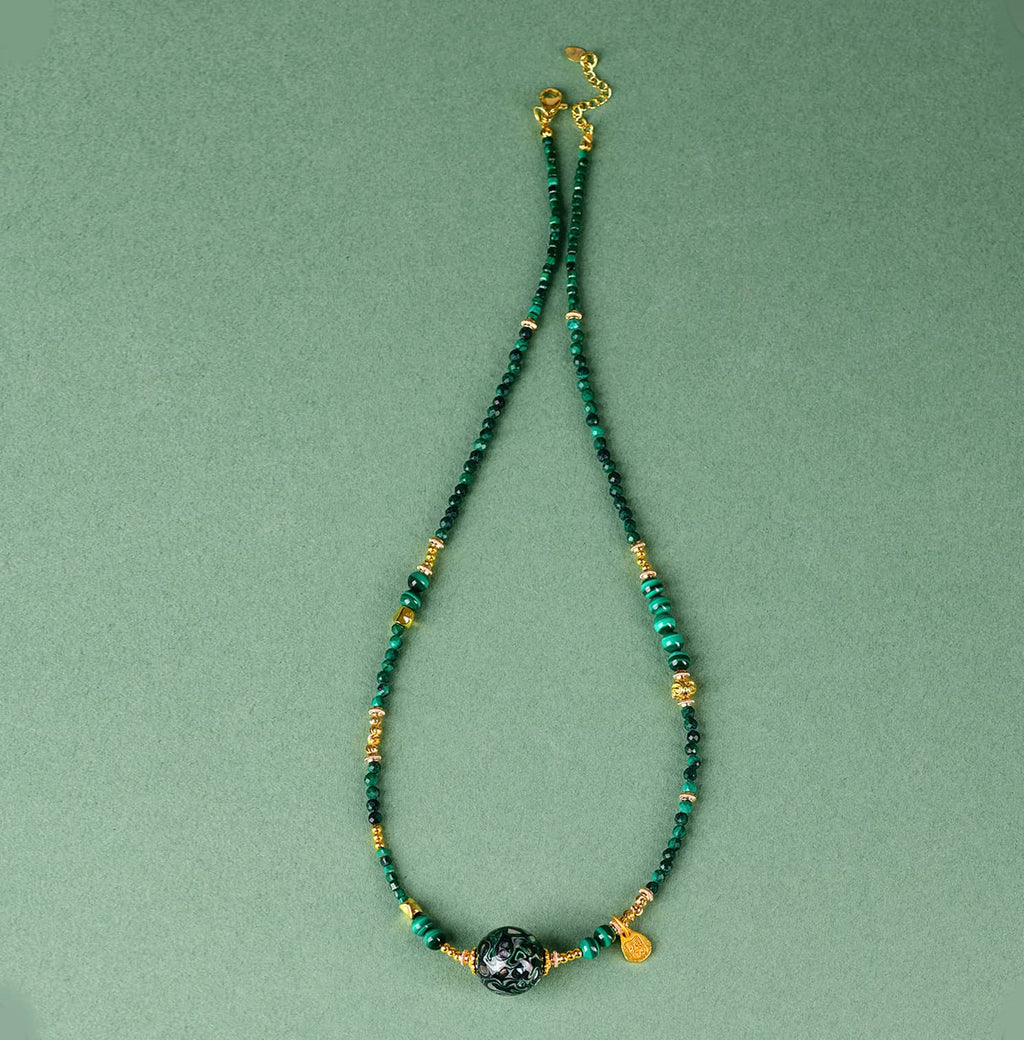 Green urushi mindfulness necklace featuring natural stones and gold accents for a calming aesthetic