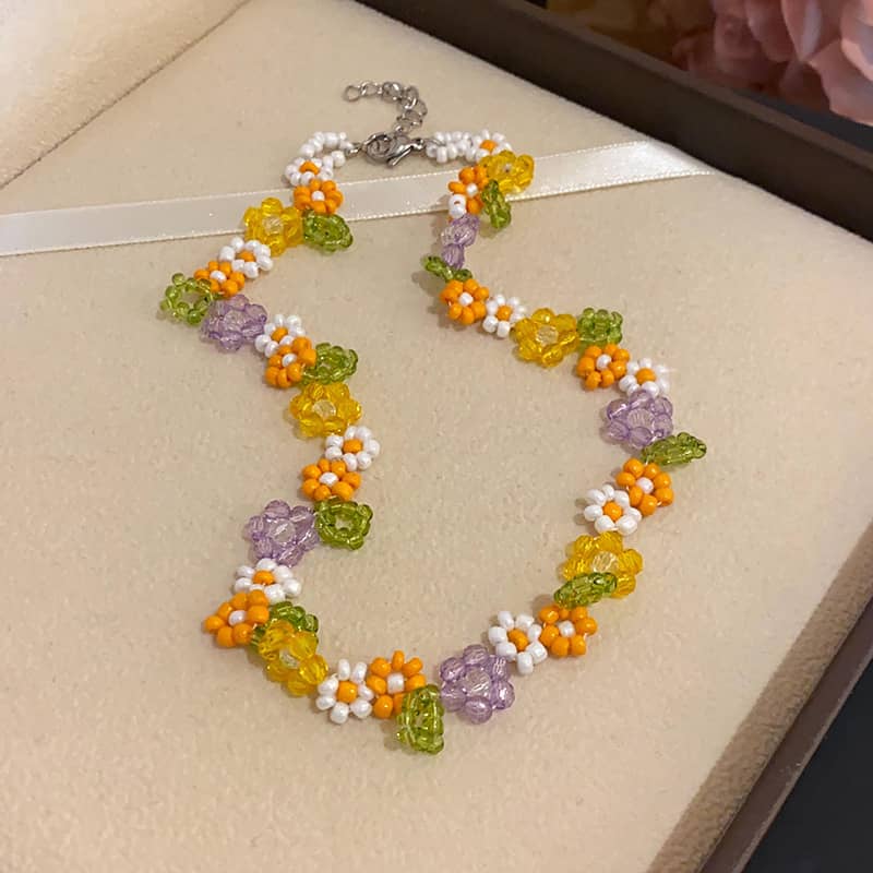 Hand-beaded floral necklace with colorful beads in yellow, orange, and purple for a vibrant accessory