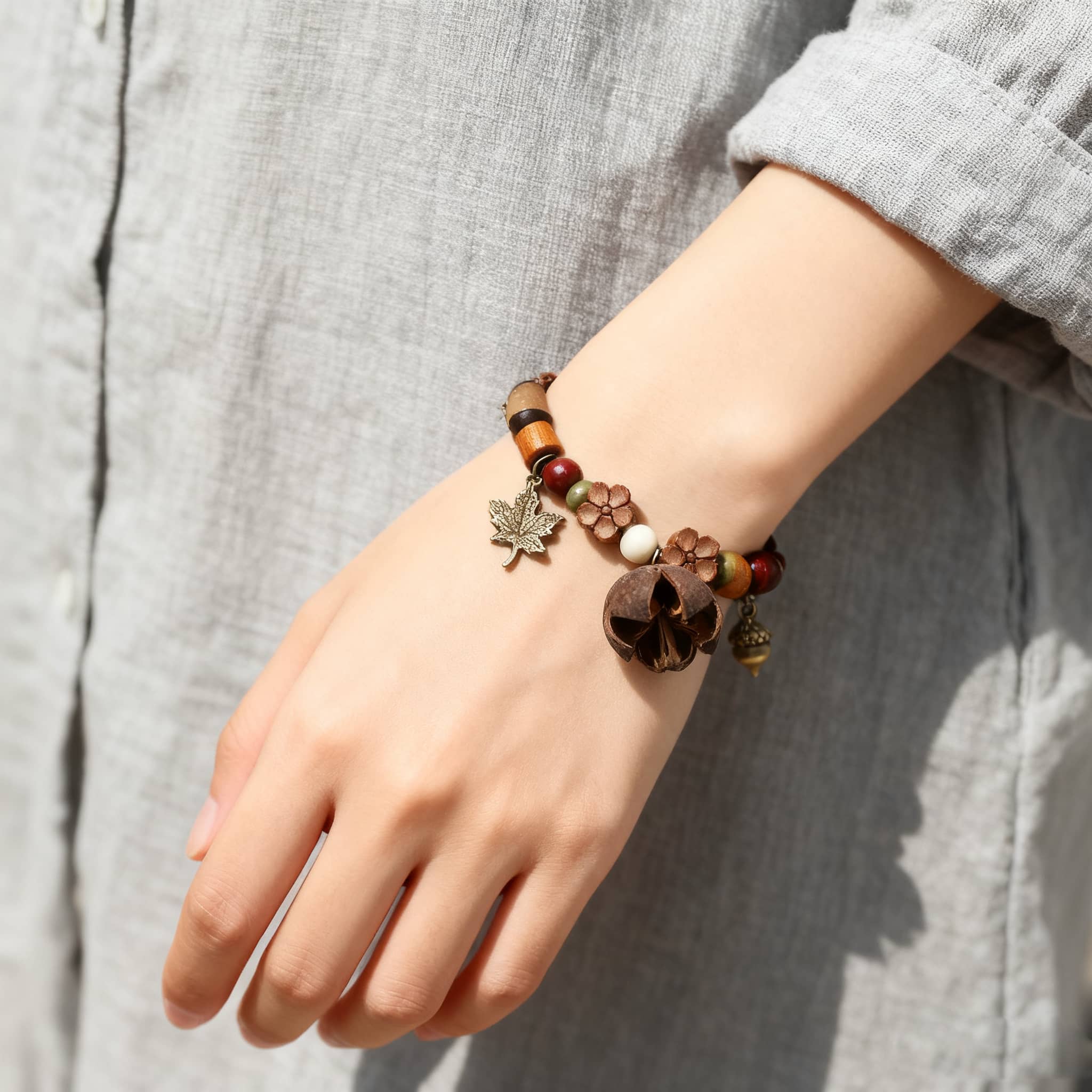 Handcrafted berry and wood bracelet featuring decorative beads and nature-inspired charms