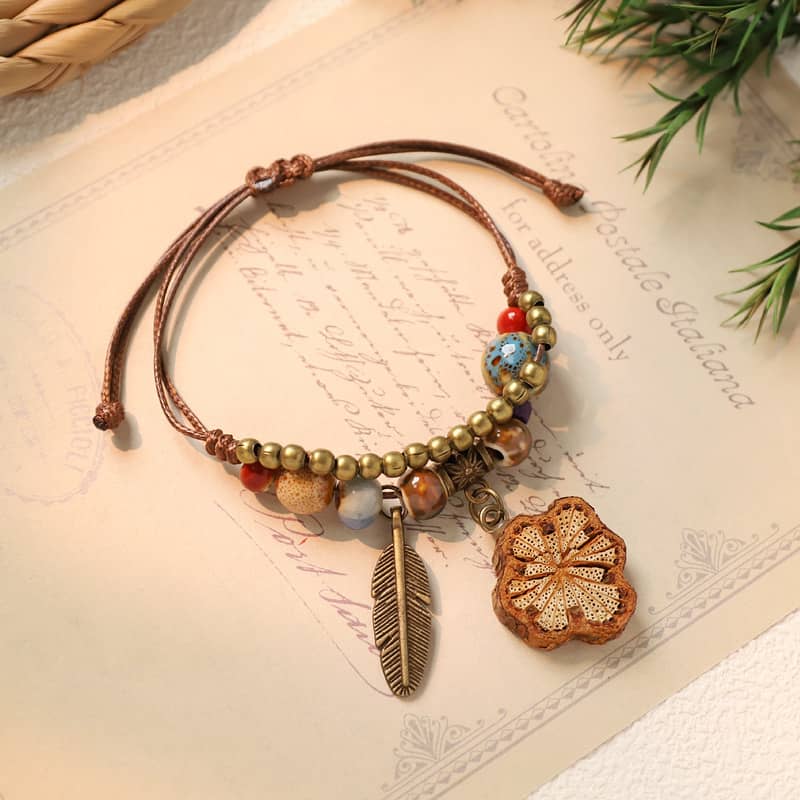 Handmade ceramic botanical bracelet with colorful beads and a flower charm for a unique accessory