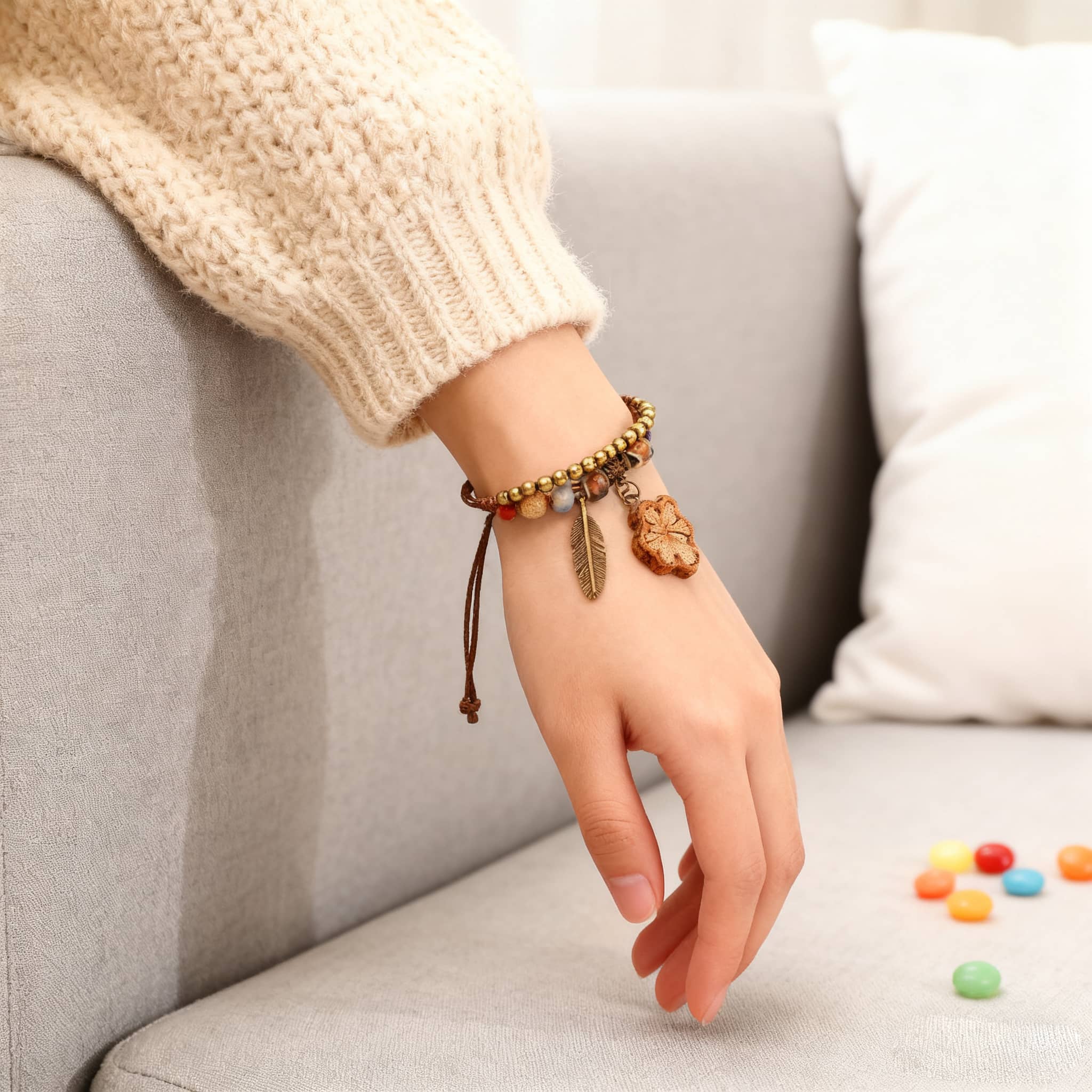 Handmade ceramic botanical bracelet with wooden charms on a person's wrist, perfect for casual wear