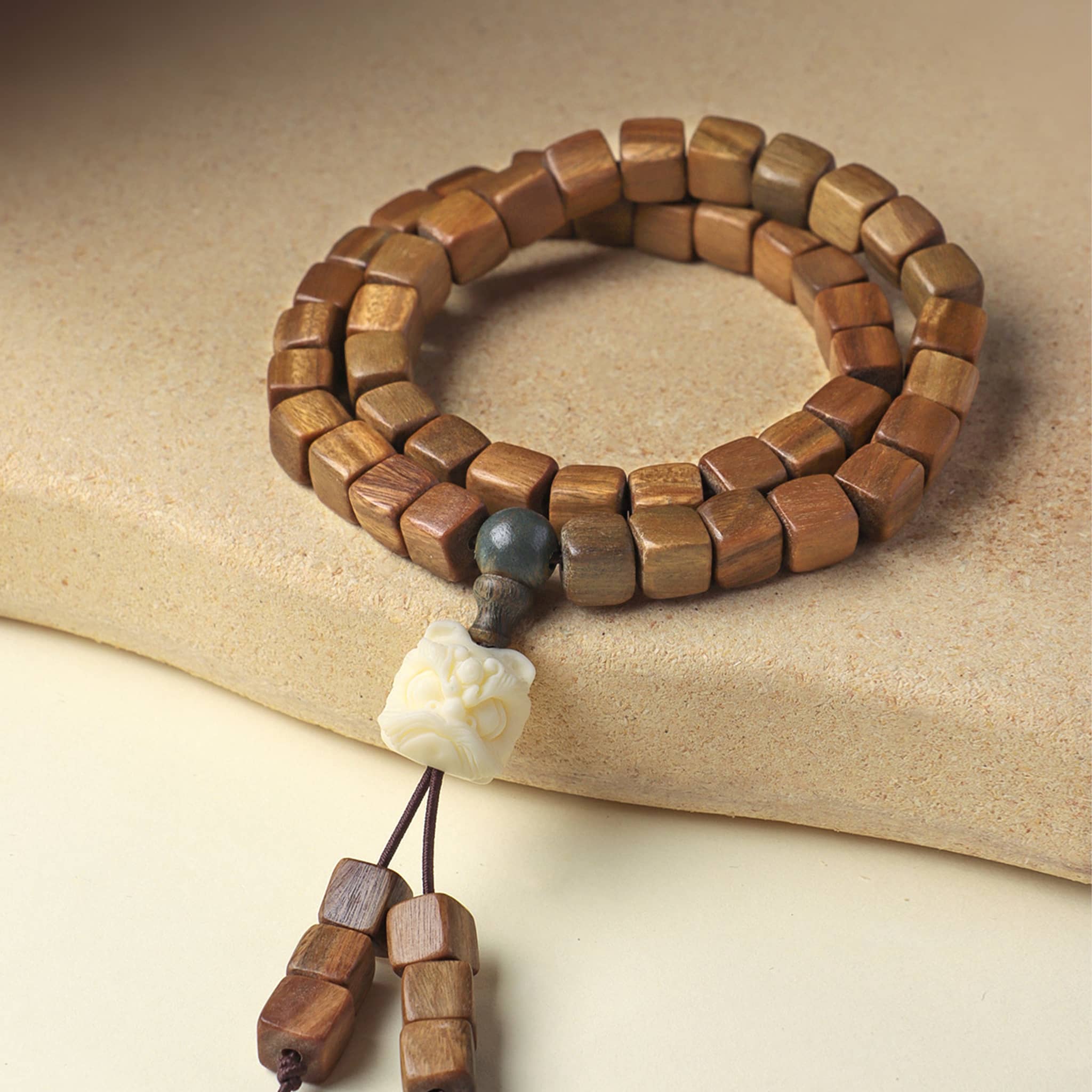 Handcrafted green sandalwood bracelet with natural wooden beads and decorative charm