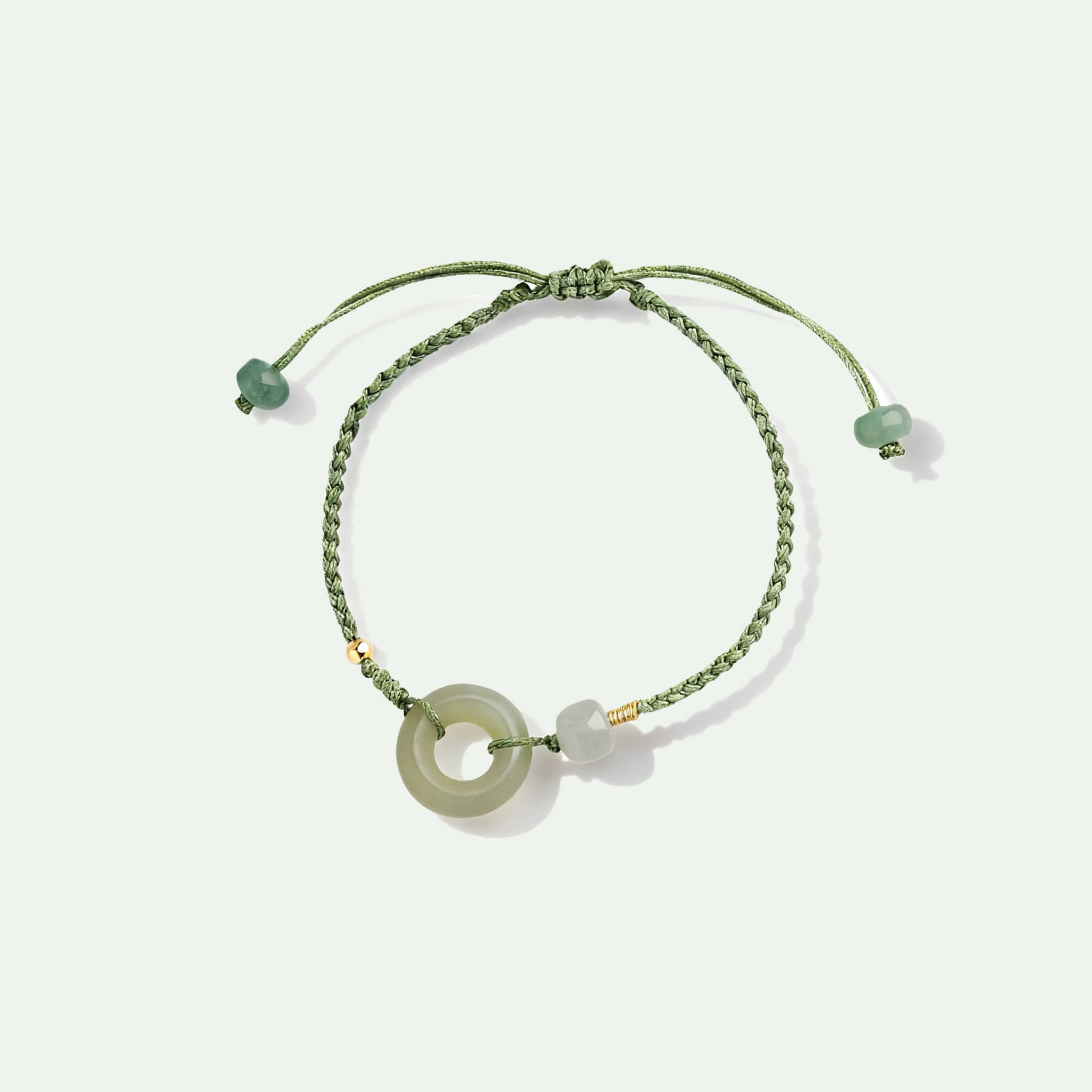 Hetian jade peace buckle bracelet with a simple green design and adjustable cord for a calming touch