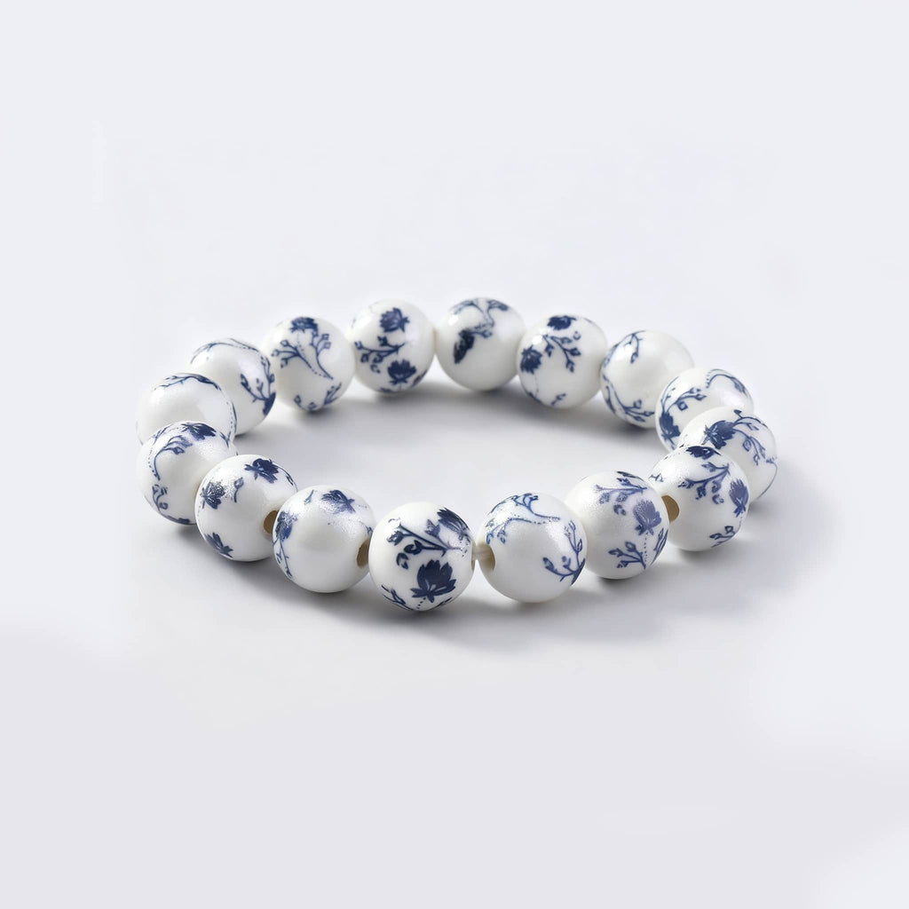 Elegant ink splash porcelain bracelet featuring blue floral patterns on a white background