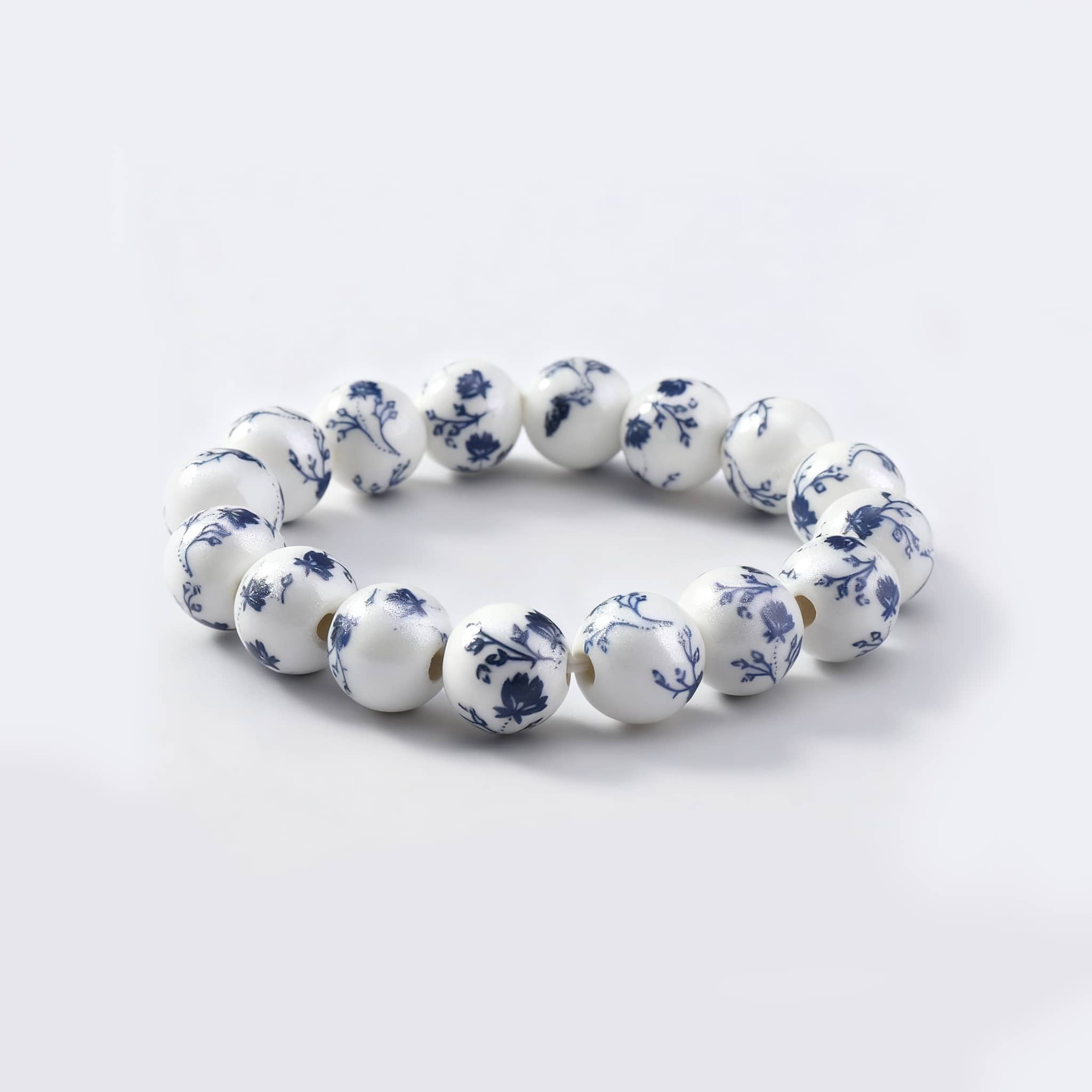 Elegant ink splash porcelain bracelet featuring blue floral patterns on a white background