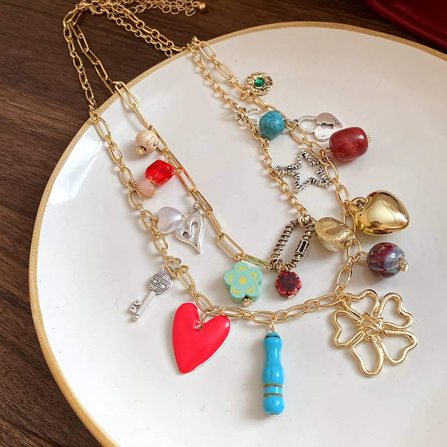 Joy charm locket layered necklace featuring colorful charms and a heart pendant for a unique style