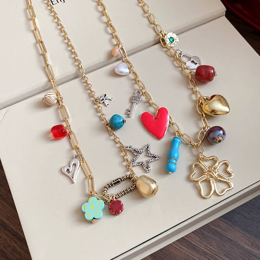 Joy charm locket layered necklace featuring colorful charms and gold chain for a trendy look