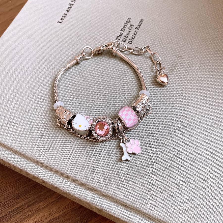 Joyful cat charm bracelet featuring colorful charms and a silver chain for playful elegance