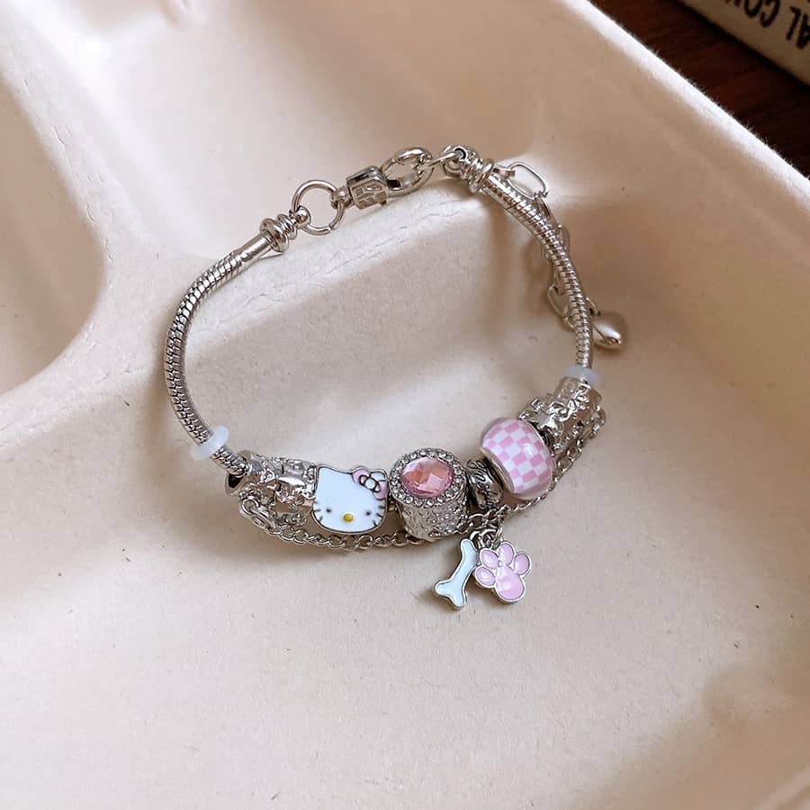 Joyful cat charm bracelet featuring Hello Kitty, pink beads and silver accents for a playful look
