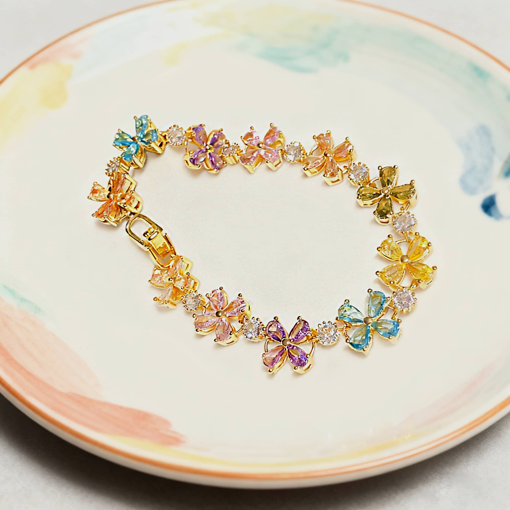 Joyful floral zirconia snap bracelet featuring colorful butterfly designs and a gold finish