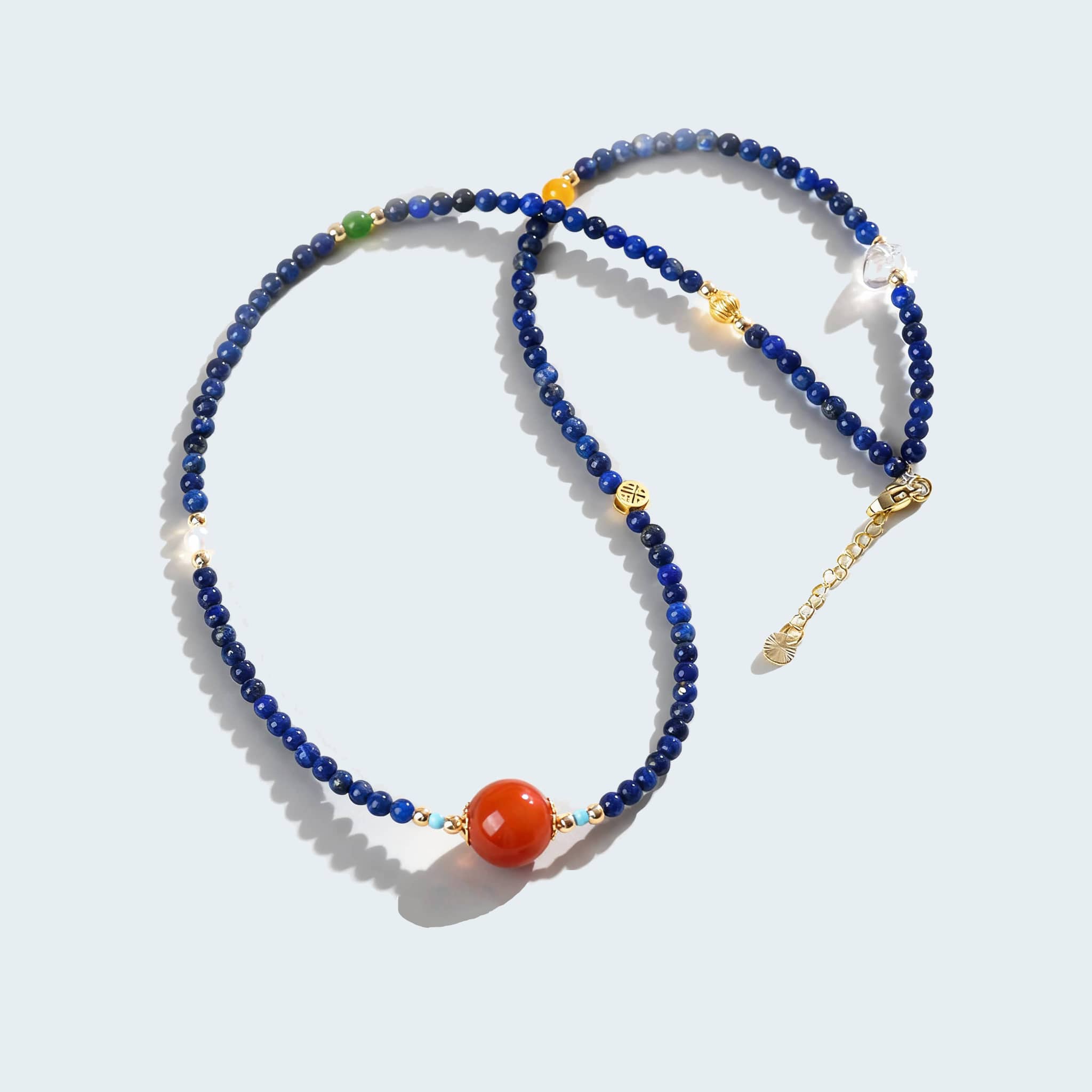 Anxious Necklace featuring lapis lazuli and red agate jewelry with gold accents