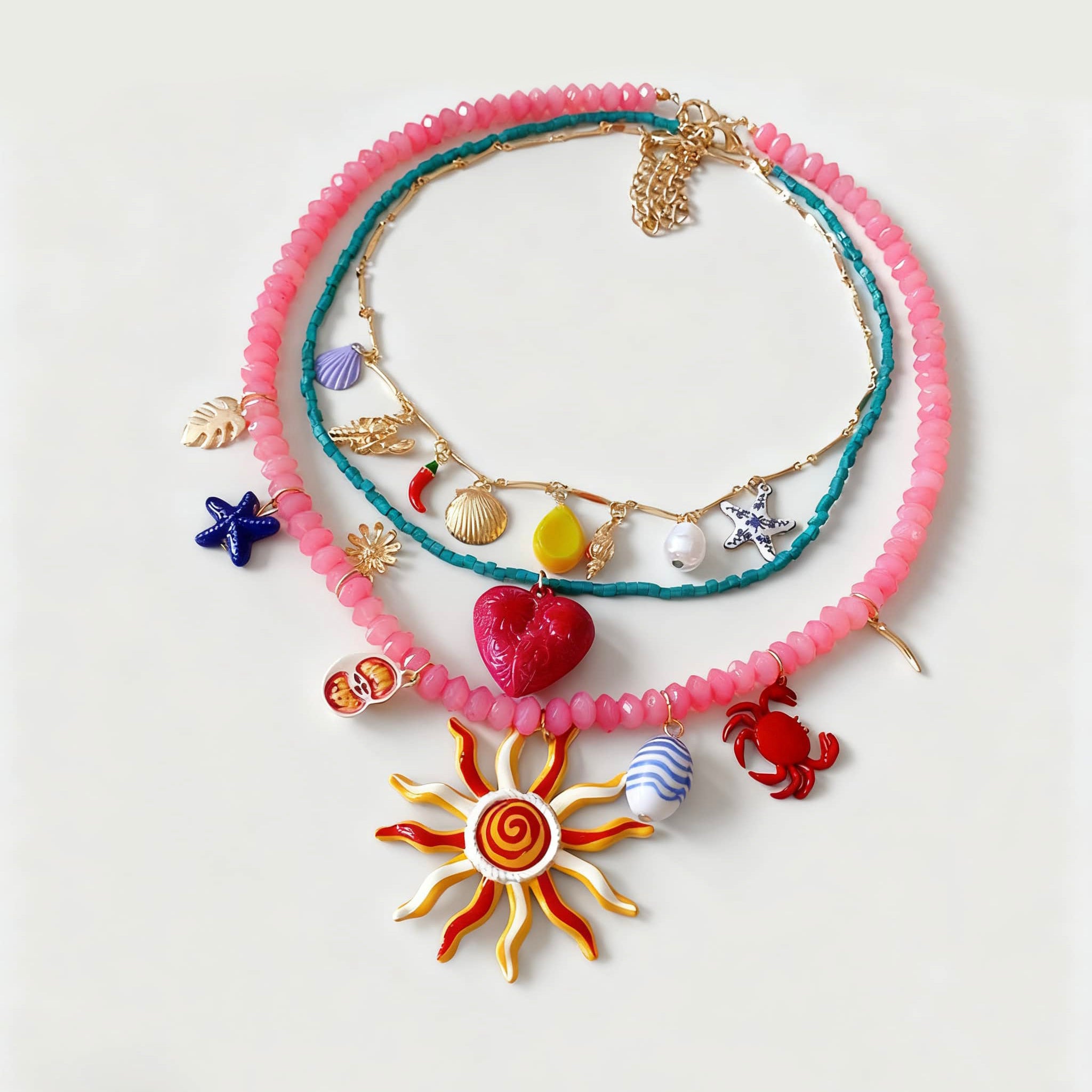 Colorful layered resin glass pendant necklace with sun, crab, and shell charms for a fun summer look