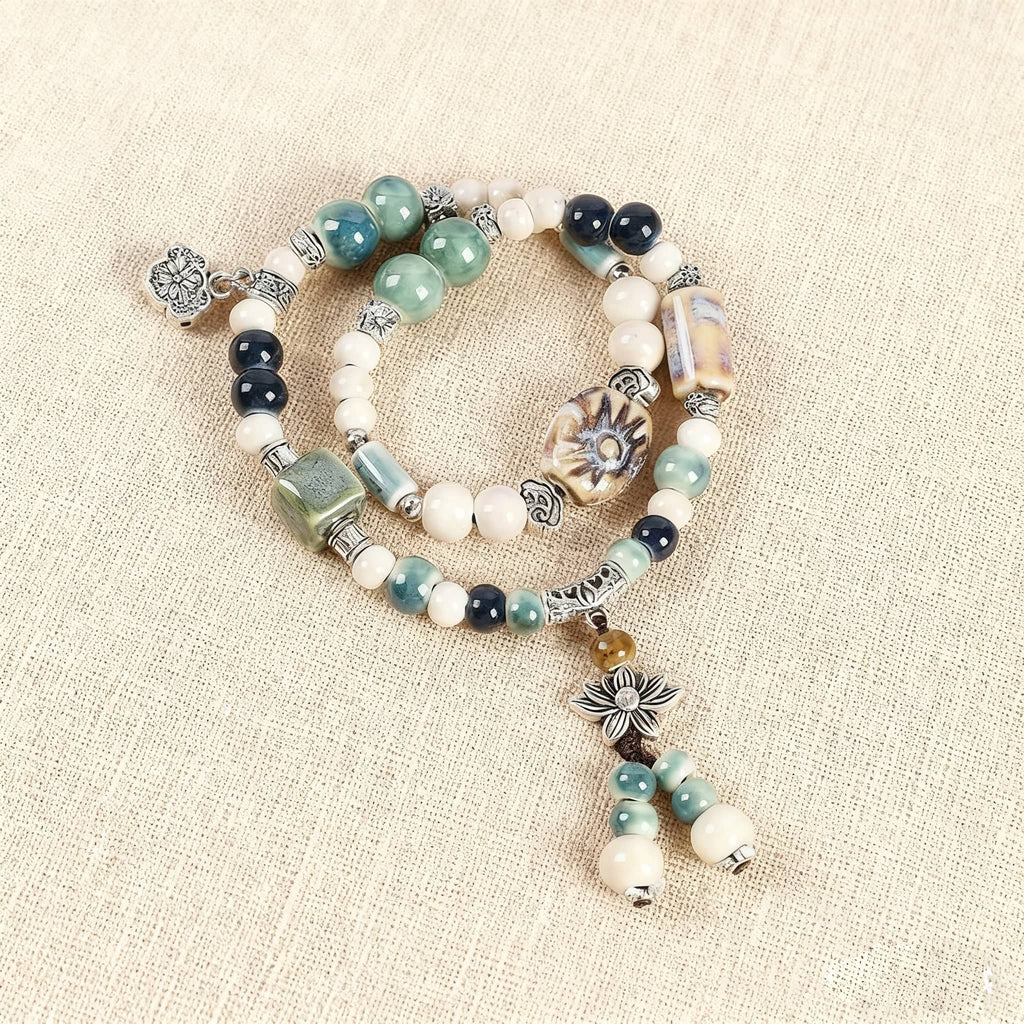 Elegant lotus ceramic bead bracelet featuring assorted beads and a charming lotus charm