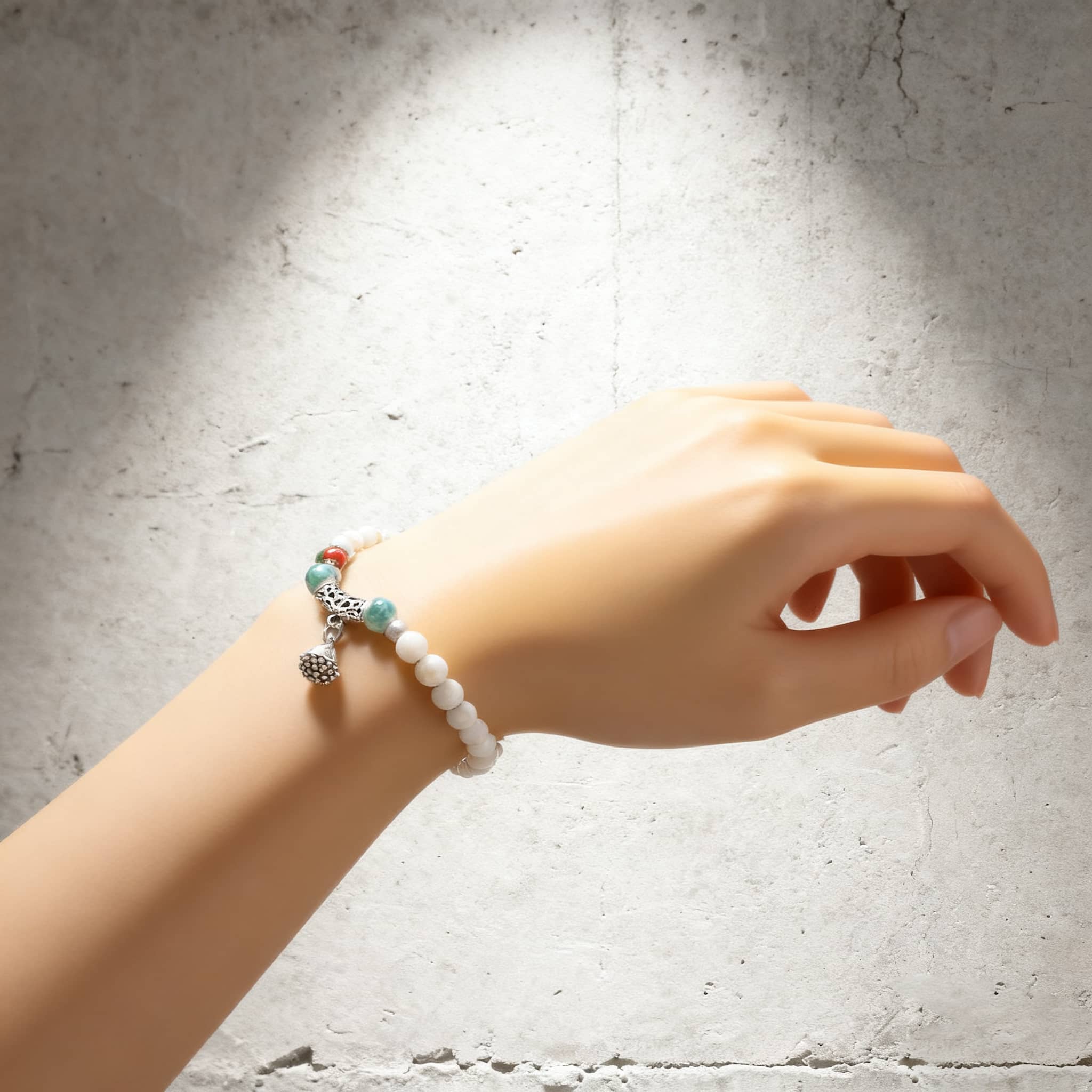 Lotus ceramic bracelet for self care displayed on a hand with decorative beads