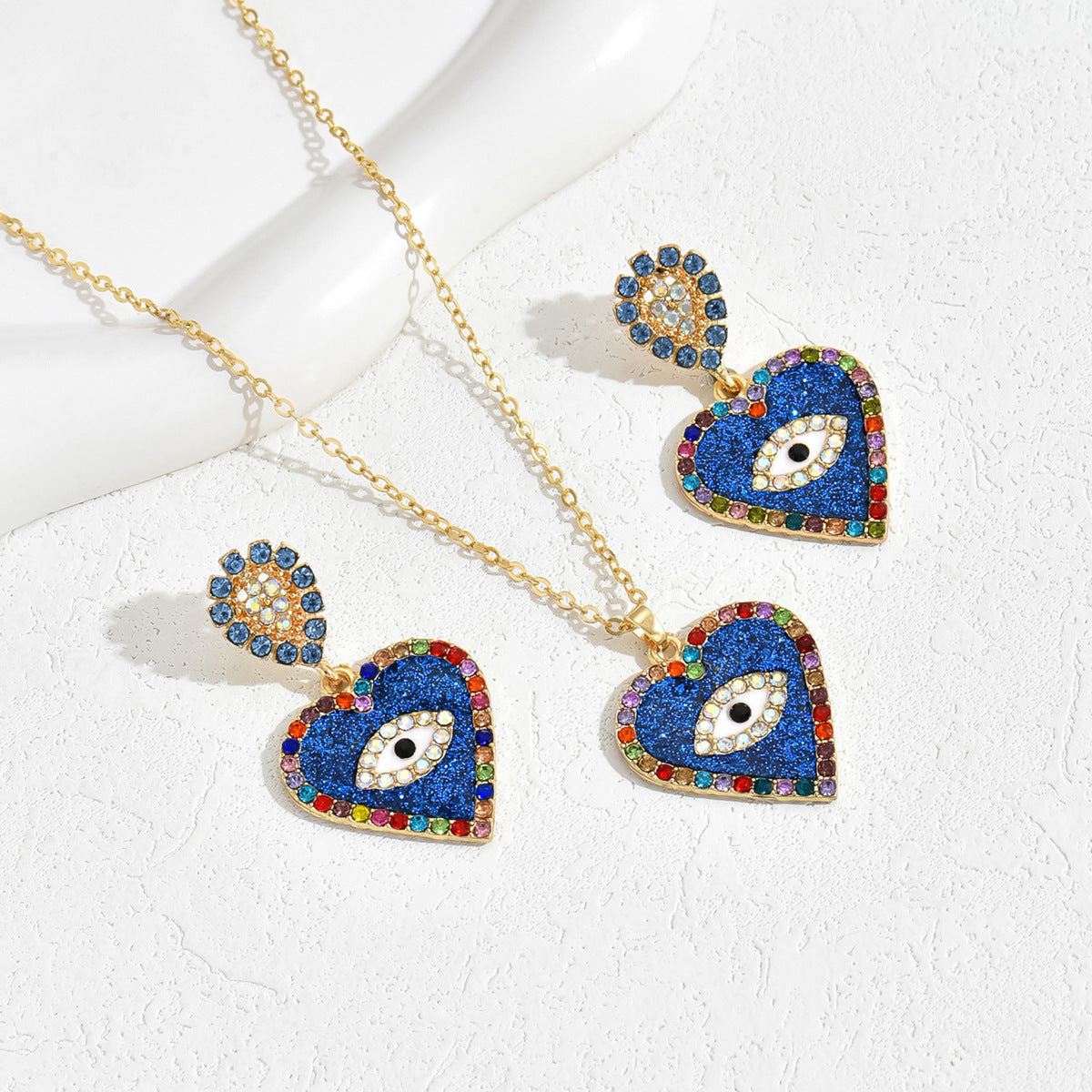 blue evil eye jewelry set gold heart necklace and matching drop earrings with multicolor crystals
