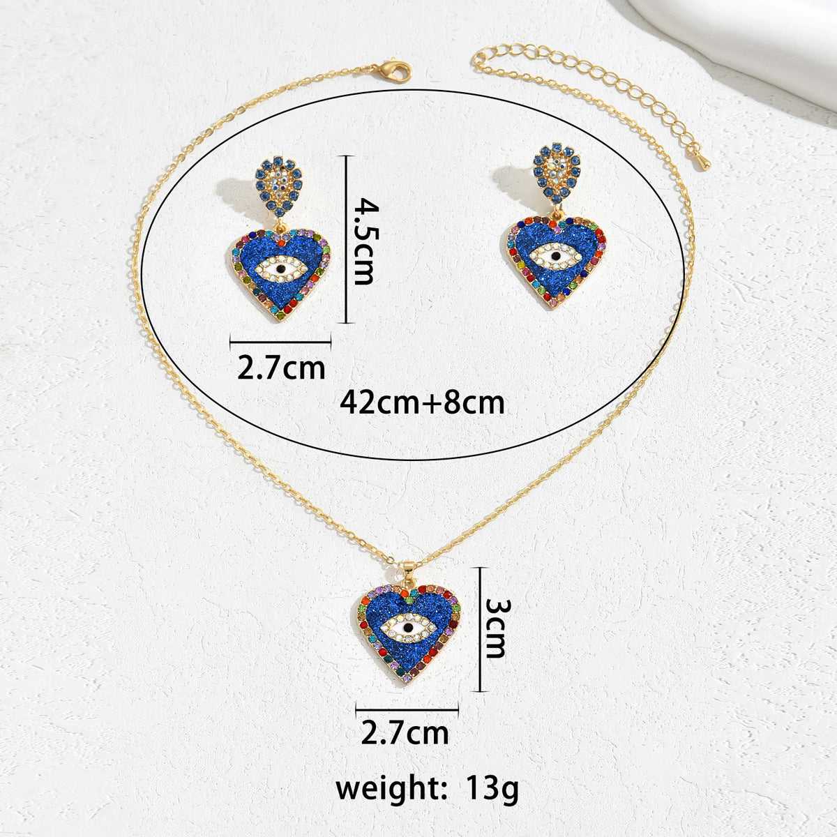 blue evil eye jewelry set with gold chain necklace and matching heart shaped blue eye earrings showing size measurements