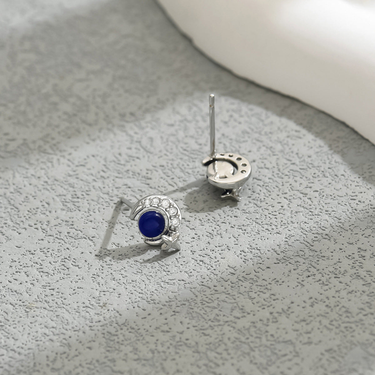 Sterling silver crescent moon star stud earrings with blue cabochon center and crystal halo accents