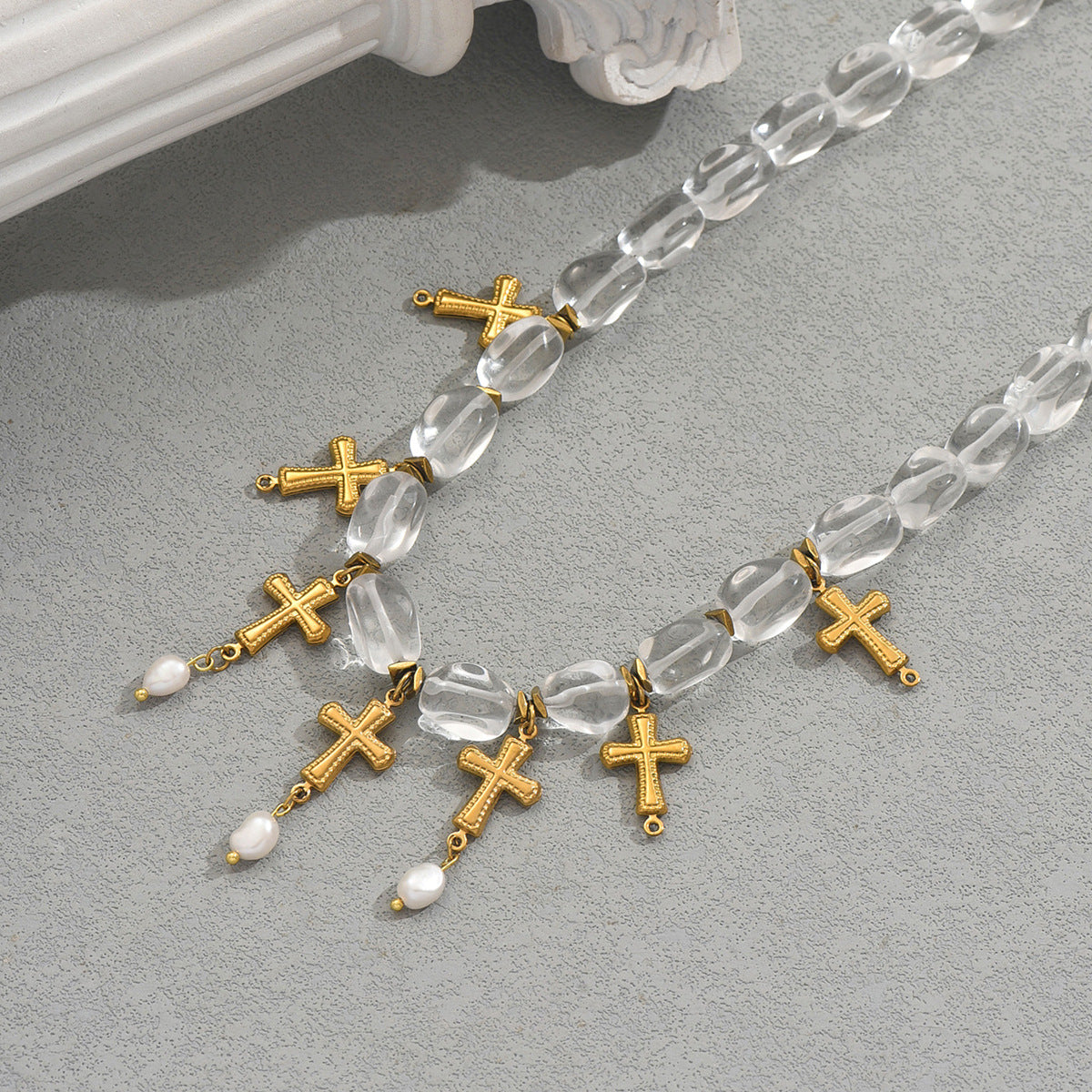 gold cross pearl necklace with clear faceted beads and dangling gold crosses and small freshwater pearls