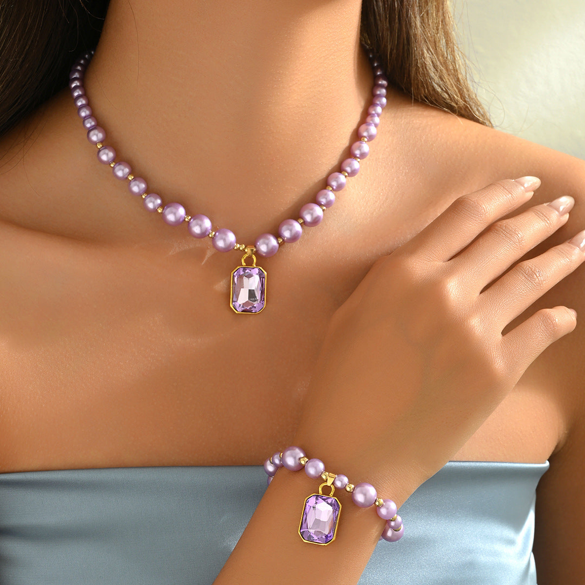 Model wearing purple zircon pearl jewelry set with beaded pearl necklace and matching bracelet with faceted pendant