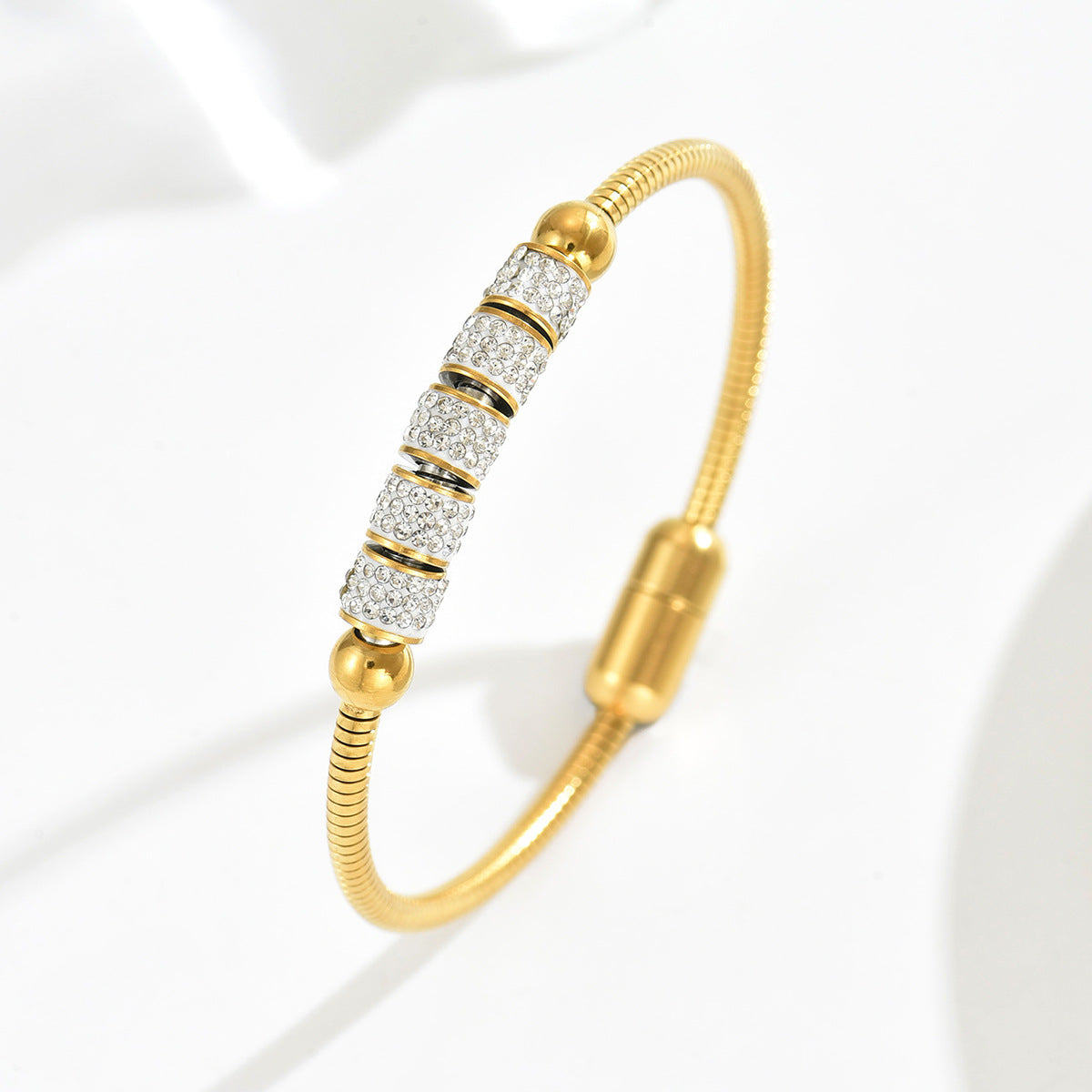golden geometric magnetic bracelet with crystal encrusted cylinder bead and secure magnetic clasp