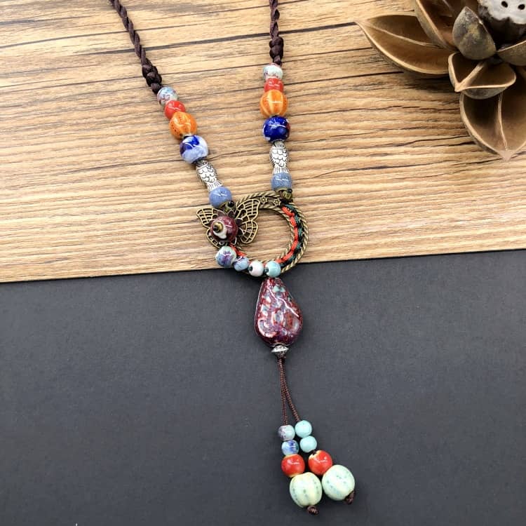Meaningful ceramic and linen necklace featuring colorful beads and a decorative pendant