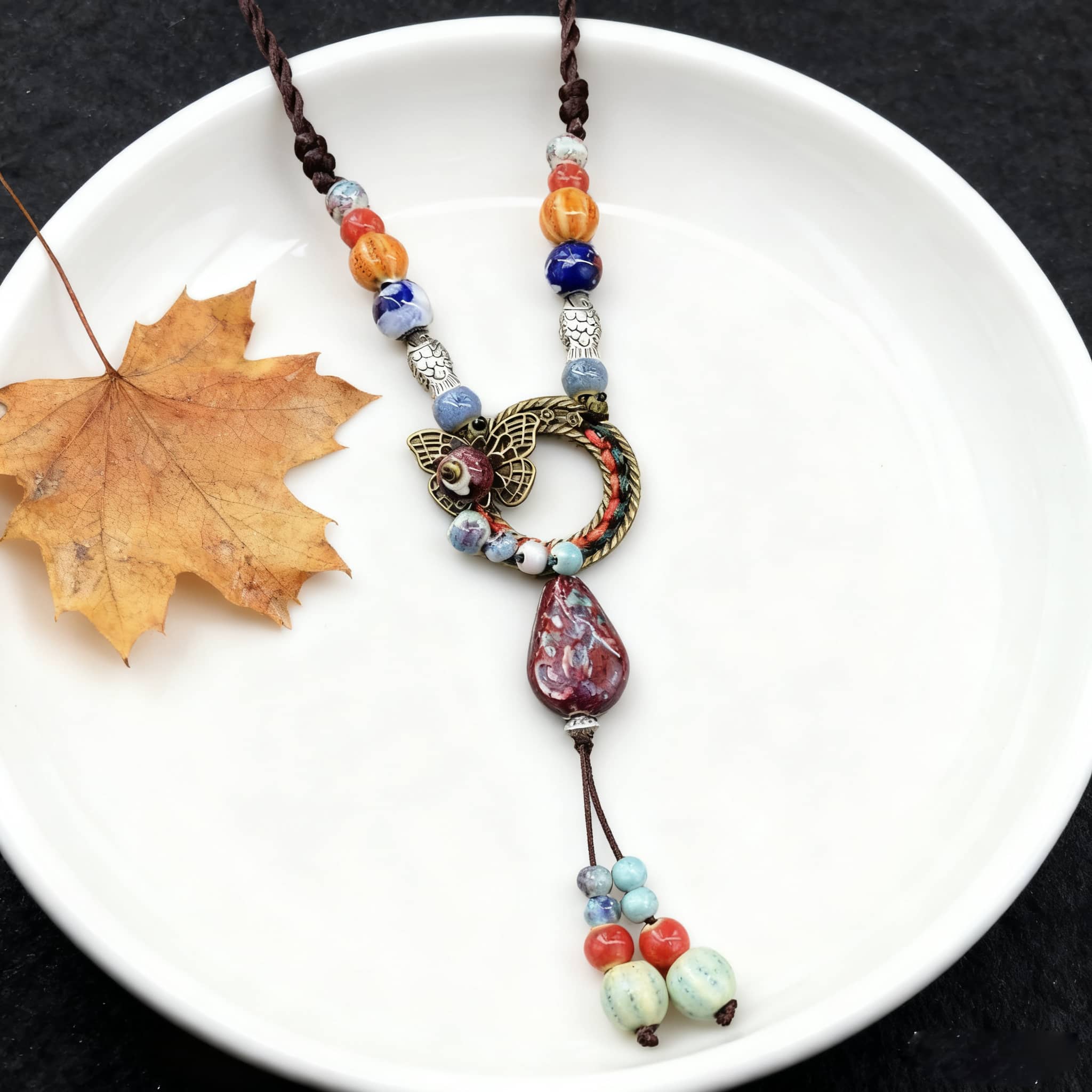 Meaningful ceramic and linen necklace with colorful beads and a decorative pendant