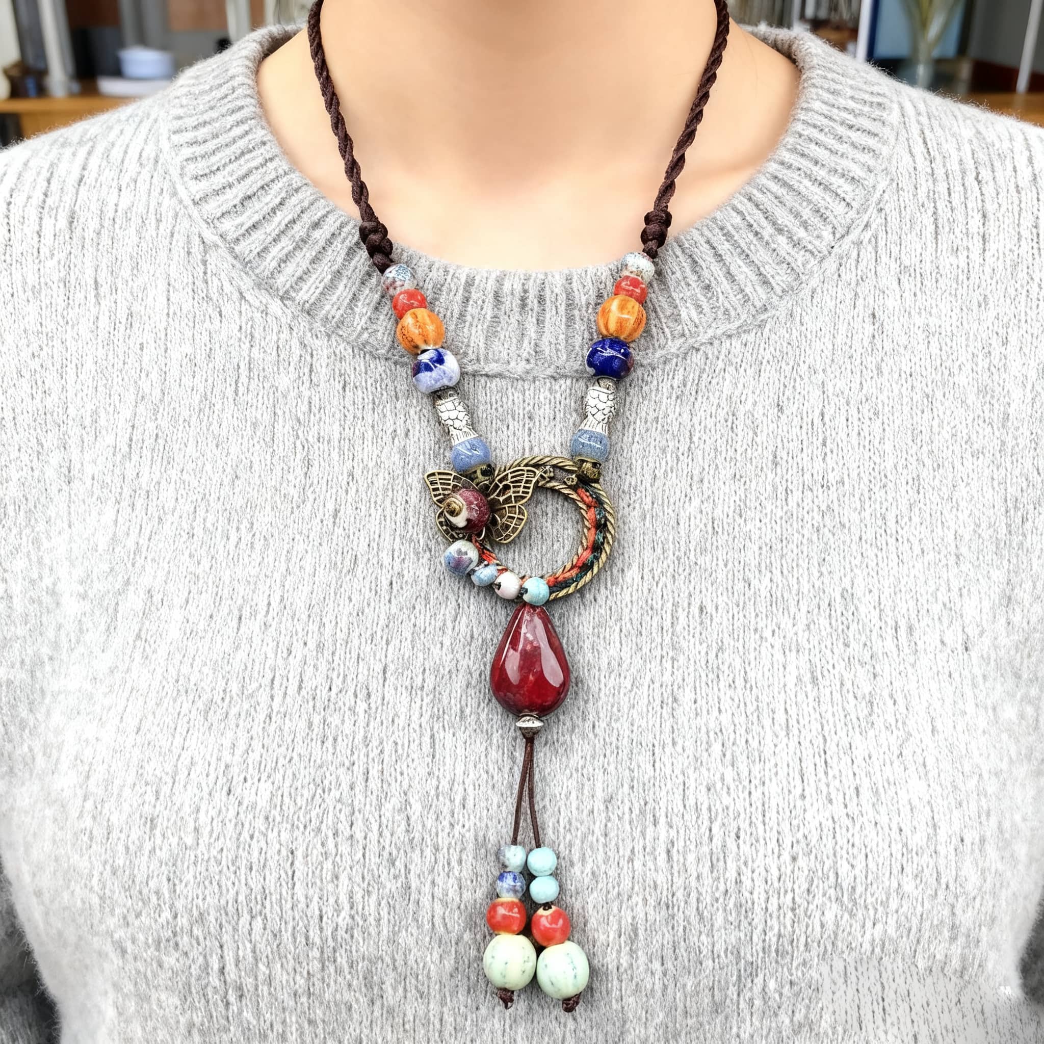Insecure necklace featuring meaningful ceramic and linen necklace with colorful beads and intricate designs